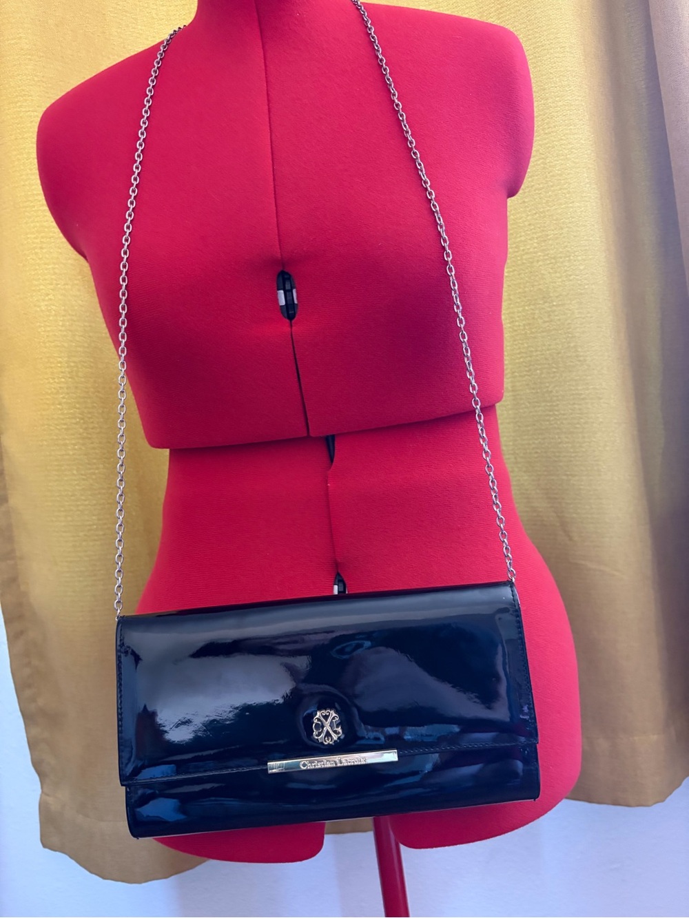 Christian Lacroix, black patent leather clutch with gold emblem